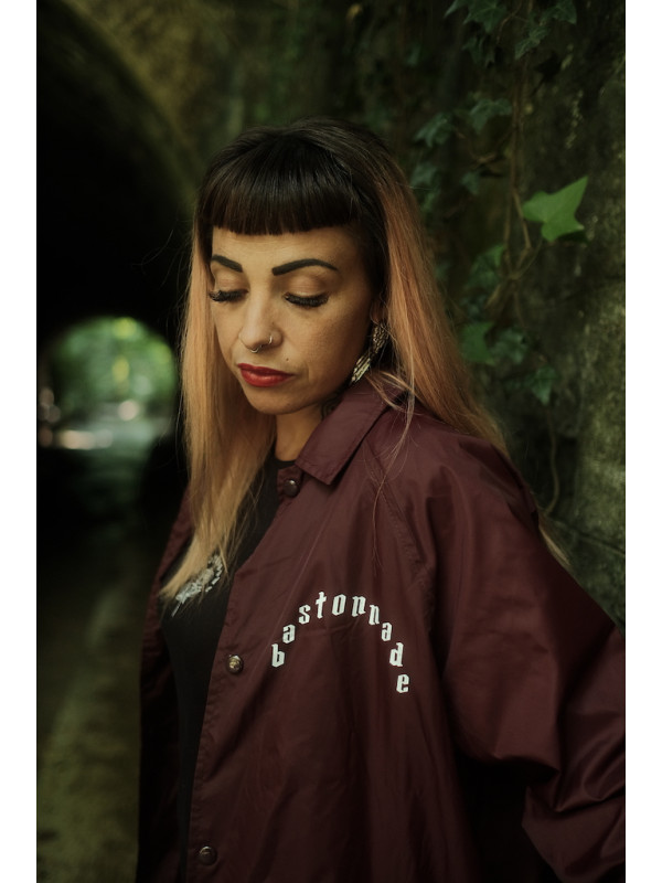 Cécile wears the 'Dead Heart' coach jacket/windbreaker for men and women by swiss streetwear brand bastonnade clothing.